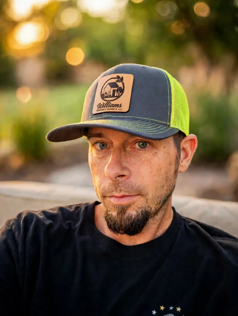 Kyle Williams, founder of Williams Property Experts LLC, wearing a company hat